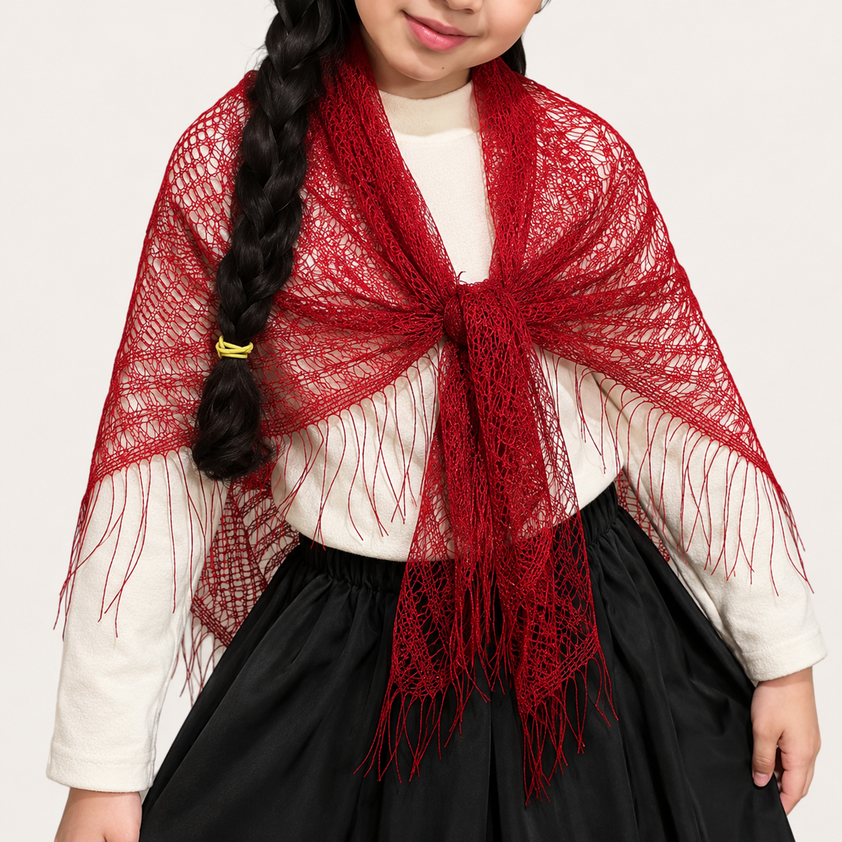 Niña usando mantón triangular infantil de encaje rojo con flecos para traje típico